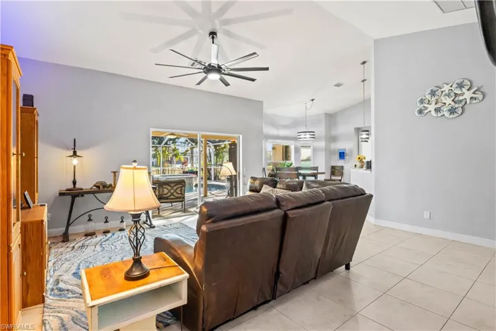 Living room opens to the kitchen and dining area with access to the outdoor living.
