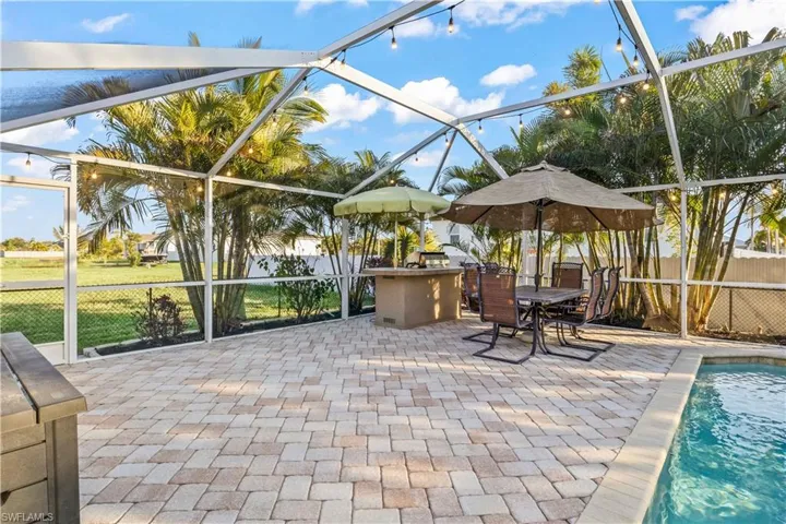 Enjoy grilling out with family and friends on the lanai that is screened in and has a fenced backyard
