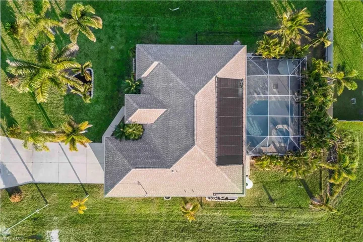 Beautifully landscaped home surrounded by mature tropical greenery, creating a private oasis and serene Florida paradise.