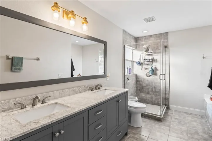 Spa-inspired primary bath with dual sinks, a walk-in shower, and modern finishes for comfort and convenience.