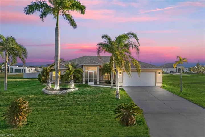 A beautiful front exterior showcasing the home’s lush tropical landscaping and inviting curb appeal.