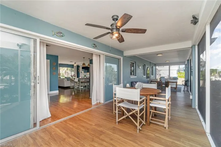Dining room with light wood-style floors and ceiling fan