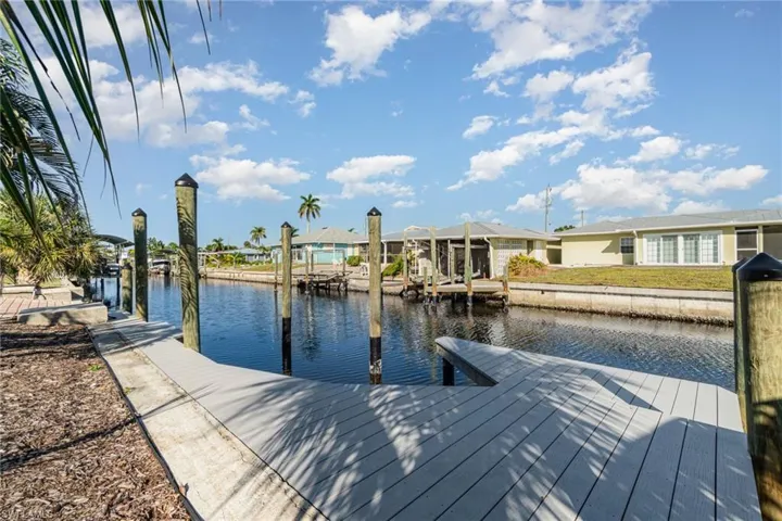 Dock featuring a water view, a residential view, and boat lift