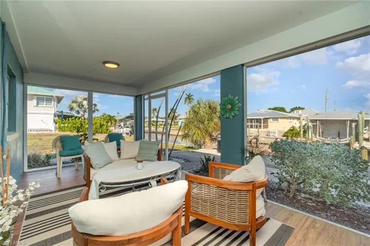 Sunroom / solarium with wood finished floors and a residential view