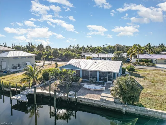 Back of property with a water view and a sunroom