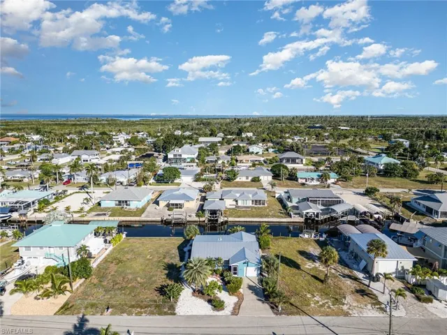 Aerial perspective of suburban area featuring a large body of water