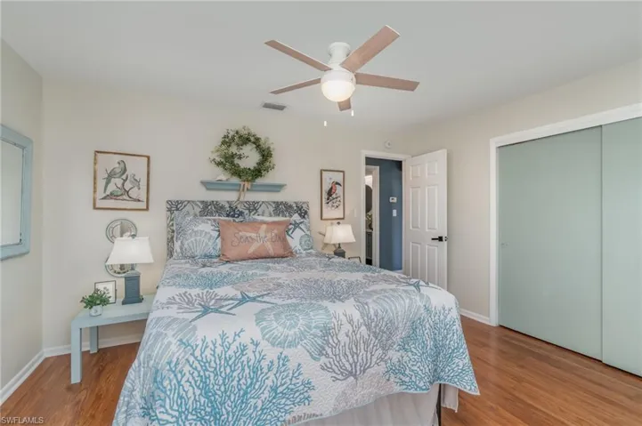 Bedroom featuring wood finished floors, ceiling fan, and a closet