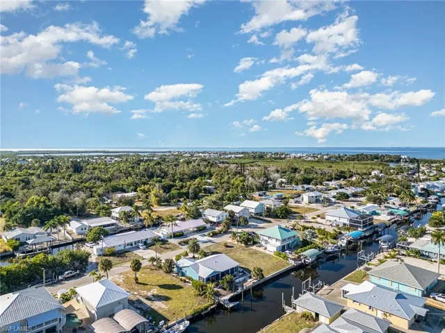 Aerial perspective of suburban area featuring a nearby body of water