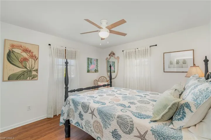 Bedroom with wood finished floors and a ceiling fan