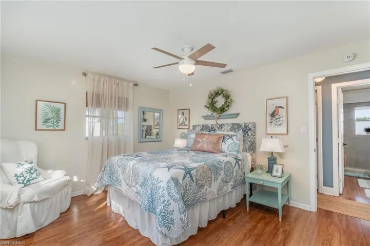 Bedroom with wood finished floors and a ceiling fan
