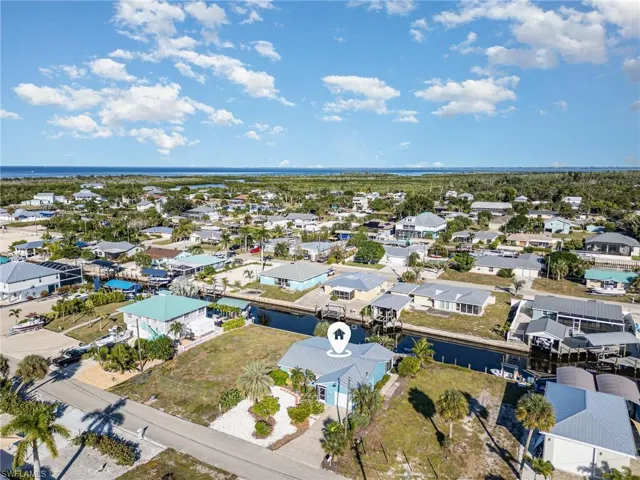 Aerial perspective of suburban area featuring a nearby body of water