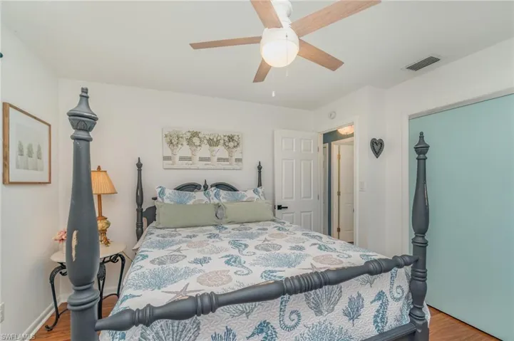 Bedroom featuring light wood-type flooring, ceiling fan, and a closet