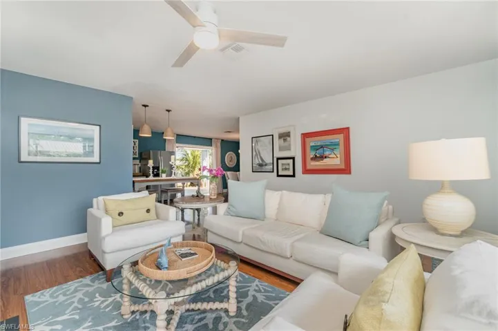 Living area with wood finished floors and ceiling fan