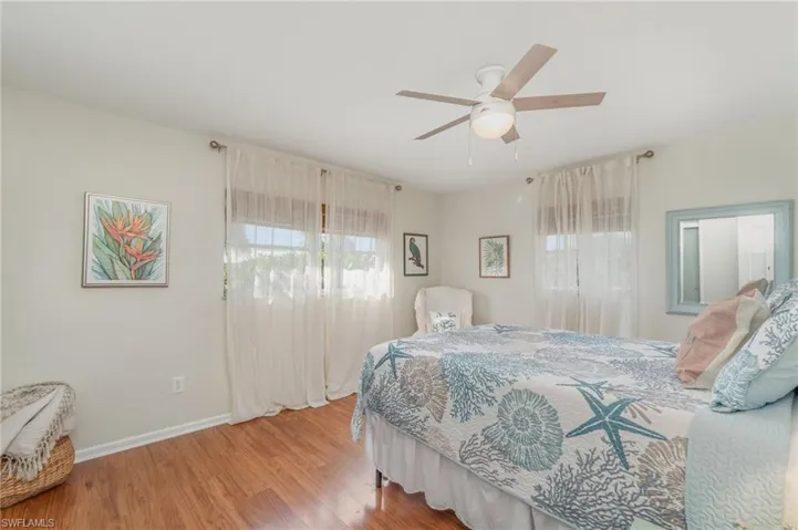Bedroom with wood finished floors and a ceiling fan