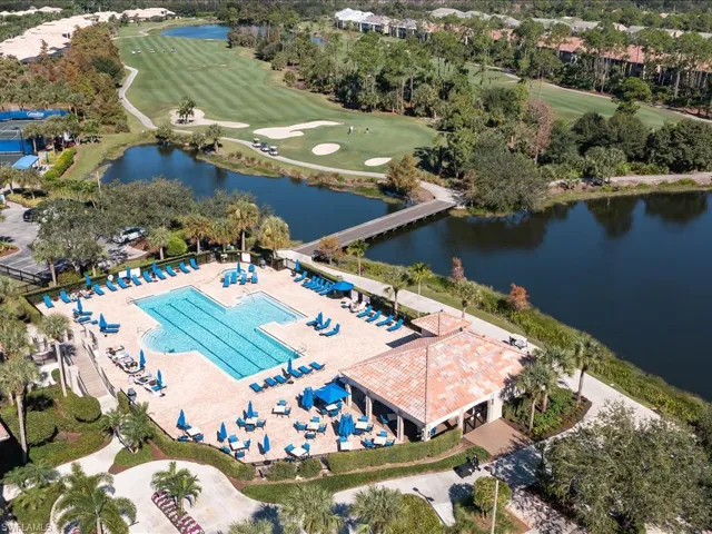 Birds eye view of property with a water view