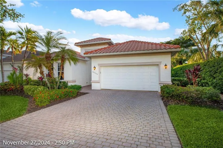 Mediterranean / spanish-style home with a garage