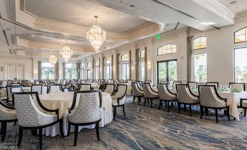 Dining room with an inviting chandelier, plenty of natural light, and crown molding
