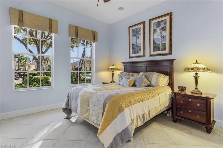 Bedroom with light tile patterned floors and ceiling fan