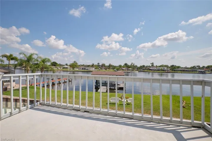 Balcony with a dock and a water view