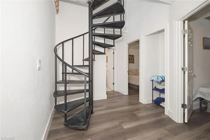 Stairway featuring dark wood-type flooring