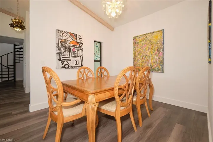 Dining space featuring dark hardwood / wood-style floors and a chandelier