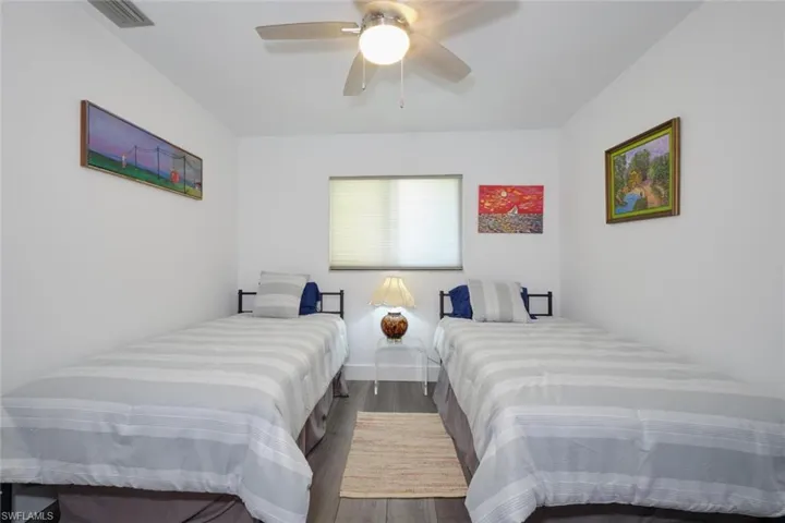 Bedroom with hardwood / wood-style floors and ceiling fan