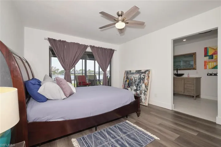 Bedroom featuring dark hardwood / wood-style floors and ceiling fan