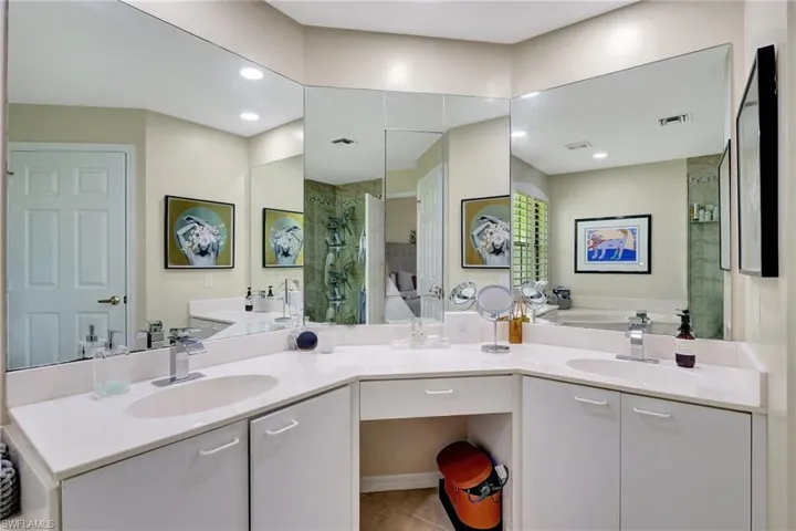 Full bath featuring visible vents, a stall shower, a bath, and a sink