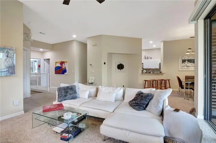 Living area featuring baseboards, recessed lighting, and carpet floors