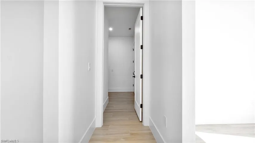 Corridor with light wood-type flooring