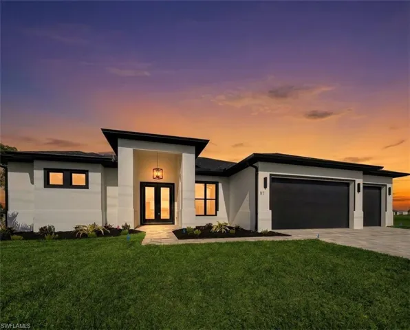 Modern architectural exterior featuring a prominent entryway with double glass doors and a contemporary hanging fixture