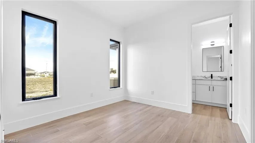 Unfurnished room featuring plenty of natural light and light hardwood / wood-style flooring