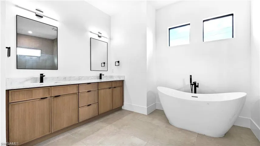 Bathroom with a tub to relax in and vanity