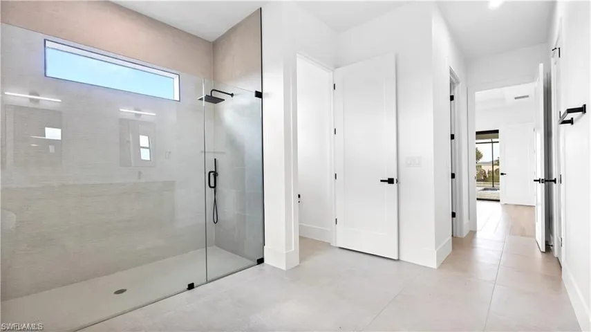 Bathroom with tile patterned floors and an enclosed shower