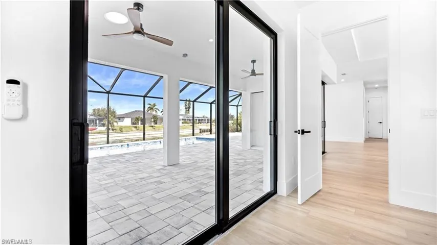 Doorway to outside featuring ceiling fan and light hardwood / wood-style floors