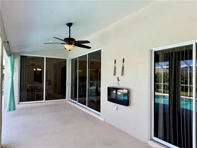 View of undercover area featuring ceiling fan and electric fireplace