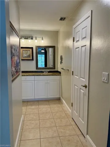 Bathroom featuring light tile patterned floors and vanity