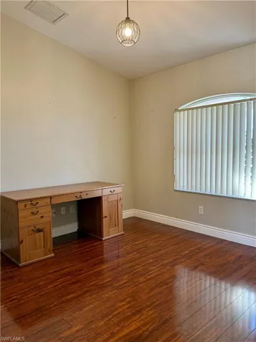 Office featuring dark wood-style flooring