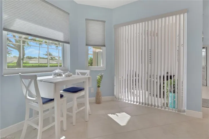 Dining Area off the kitchen (behind the breakfast bar) well lit view to the lanai and back yard.