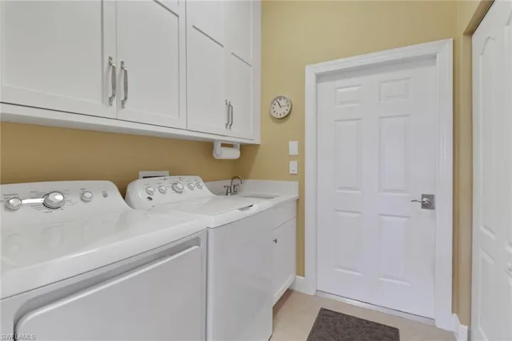 Laundry area right off garage to easily drop things in tub, tile floors, cabinet space, and separate washer and dryer for convience.