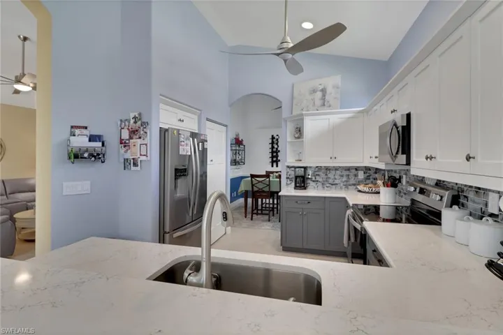 Kitchen view from the bar showing dining room straight through and living room entry to the left