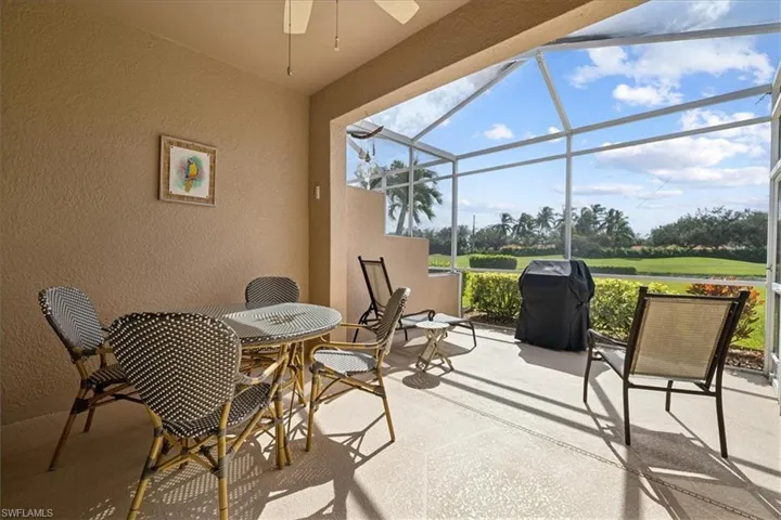 View of patio featuring area for grilling, a lanai, and ceiling fan