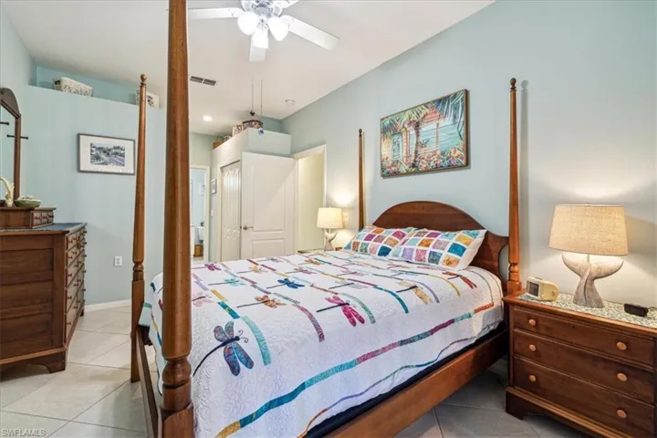 Tiled bedroom featuring a closet and ceiling fan