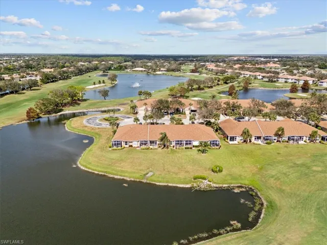 Birds eye view of property with a water view