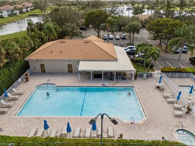 View of swimming pool with a water view and a patio