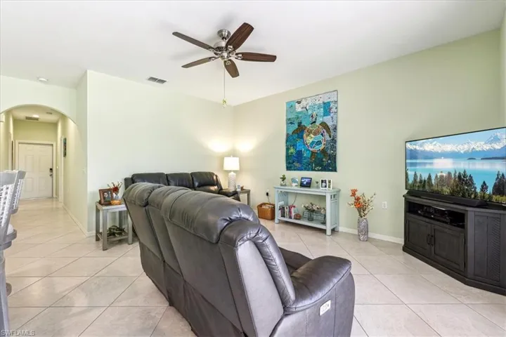 Living room featuring ceiling fan and light tile patterned floors