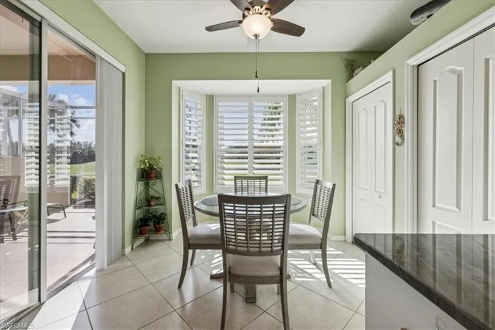 Dining area featuring ceiling fan and light tile patterned floors