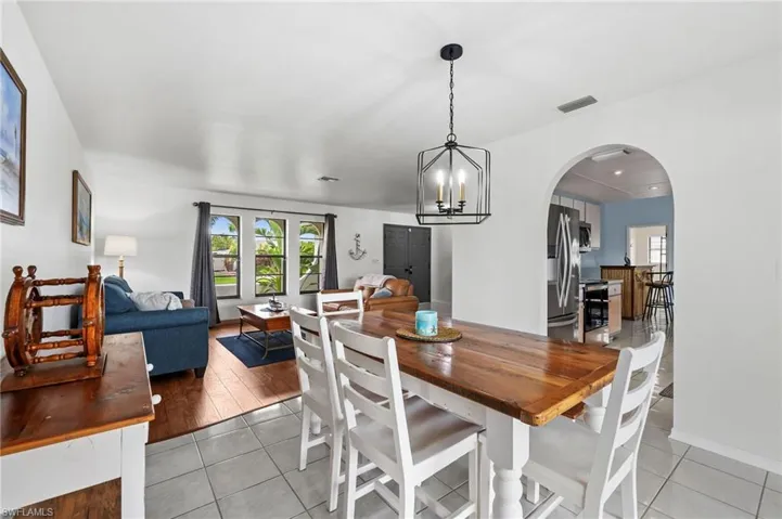 Dining room with view of pool and living room