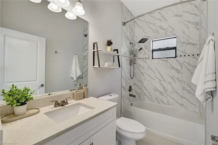 Bathroom featuring vanity and shower / bathtub combination