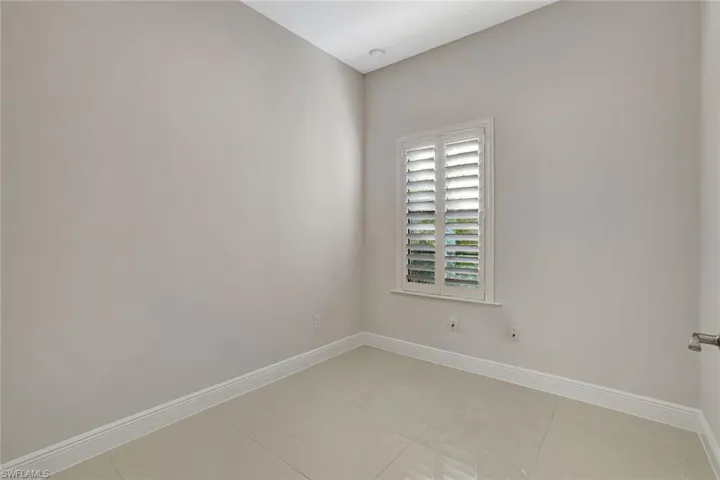 Unfurnished room featuring baseboards and light tile patterned floors